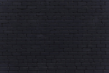 Black brick wall. Background in loft style. Brickwork. Wallpaper made of dark gray brick.