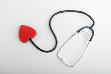 Stethoscope and red heart on white background. Follow your heart. Health concept.
