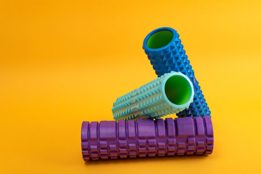 Foam rollers for myofascial release. Equipment for MFR. Fitness Equipment for Myofascial Release on yellow background. Side view