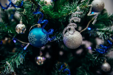 Branches of a Christmas tree decorated with toys for the new year. Christmas background.