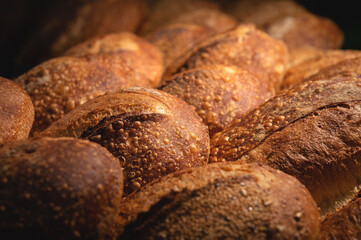 Freshly baked loaves of crispy artisan bread close up