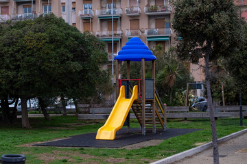 games and slides for children in the greenery of a playground on the Ligurian Riviera