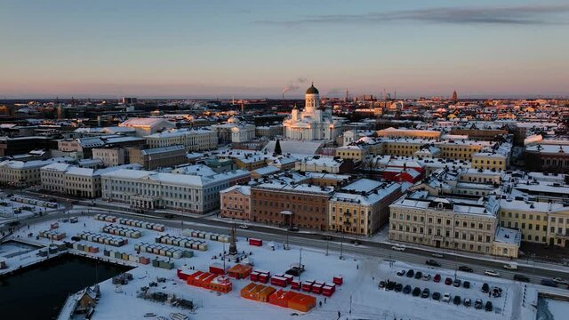 Aerial view of sunlit Helsinki south harbor, Christmas evening in Finland - rising, pull back, drone shot