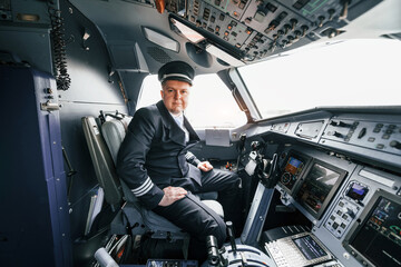 Pilot on the work in the passenger airplane. Preparing for takeoff