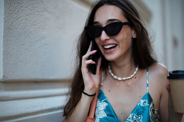 Fototapeta premium Beautiful young elegance woman using the phone. Beautiful fashion woman talking to the phone..