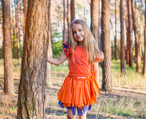 girl in a orange dress in the forest
