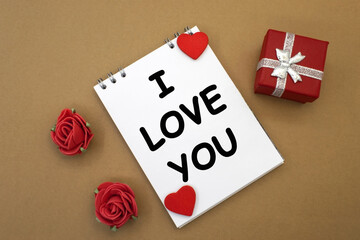 Fototapeta na wymiar I love you written on a notepad. Box and rosebuds. Valentine's Day