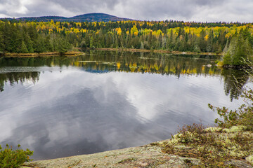 Reflection of the trees in a lake on a fall day in Mont Tremblant National Park, in Laurentides region of Quebec, Canada