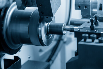 Fototapeta na wymiar The CNC lathe machine boring cutting the metal pipe parts.