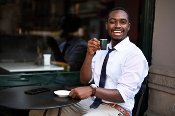 African businessman drinking coffee in cafe. Happy elegance man enjoy in fresh coffee