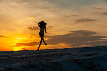Young woman jumping at sunset..