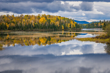 Reflection of the trees in a lake on a fall day in Mont Tremblant National Park, in Laurentides region of Quebec, Canada