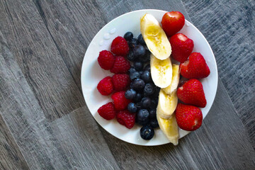 Healthy breakfast, Fresh fruits plate, Summer diet, Summer body, Strawberries, Bananas, Blueberries and Rasberries