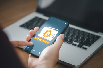 close-up of hands holding mobile phone with software  .bitcoin wallet.
