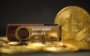 close-up of hardware wallet or digital wallet on bitcoin gold coins in cryptocurrency trading and mining investment concept.