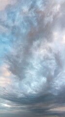 Fototapeta premium Fantastic clouds at sunrise, vertical panorama