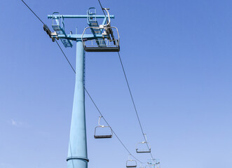 Ski lift against blue sky