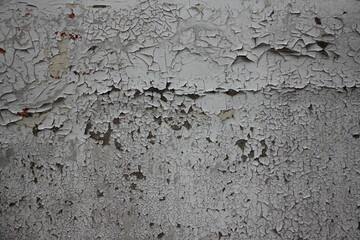 Gray painted old shabby rough abandoned wall with dark spots - loft background texture