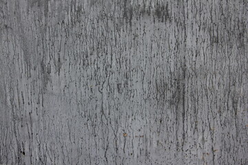 Old gray painted weathered metal wall with dark smudges abstract texture of the background