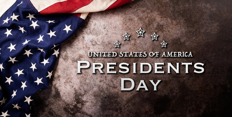 Fototapeta na wymiar Happy presidents day concept with flag of the United States on dark stone background.