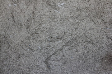 Grey dry plastered concrete with cracks and streaks close-up texture of industrial background