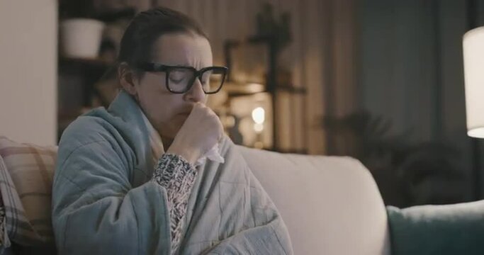 Woman with cold and flu taking a medicine