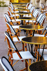 wet tables and chairs in the row - french restaurant - 478285305