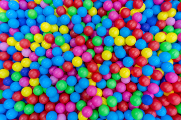 Fototapeta na wymiar A lot of colorful plastic balls in ball pool