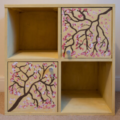 Cherry blossom branch artwork with chalk paint on old piece of  furniture. Chalk paint furniture makeover. Cupboard remodeled.