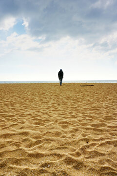 Man walking alone in Varakala beach.