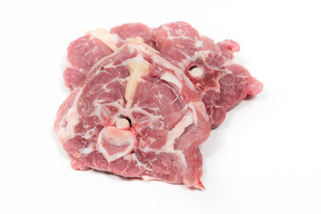 Some raw lamb neck chops on a white background