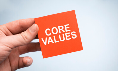Core Values word on paper in businessman hands.