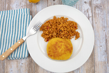 breaded meat and tomato rice on a plate