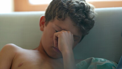 Fototapeta premium Young boy shutting down suffering in silence