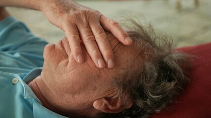 Fototapeta na wymiar Tired senior man resting on sofa, older person lying down rubbing face with hand