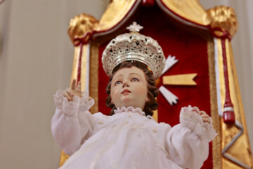 Statue of blessing Baby Jesus with a Crown and a white Robe in the main Church of Montepaone (Calabria, Italy)