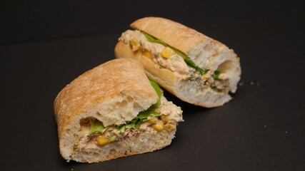 Delicious sandwich on a black background.