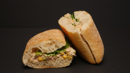 Delicious sandwich on a black background.