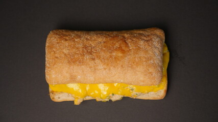 Delicious sandwich on a black background.