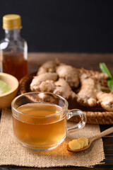 Ginger tea with lime and honey on wooden background, Healthy herbal drink