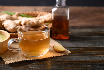 Ginger tea with lime and honey on wooden background, Healthy herbal drink