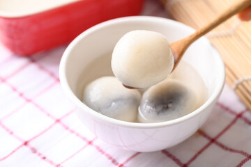Tangyuan, Chinese dessert made of ball glutinous rice flour and filled with black sesame in ginger soup or syrup