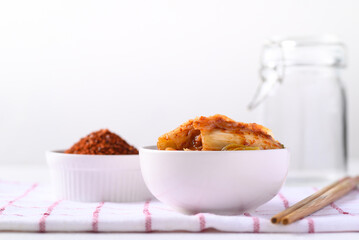 Kimchi cabbage in a bowl on white background, Korean homemade fermented side dish food