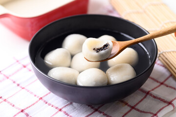 Tangyuan, Chinese dessert made of ball glutinous rice flour and filled with black sesame in ginger soup or syrup