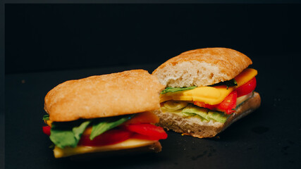Delicious sandwich on a black background.