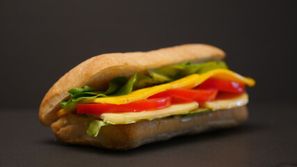 Delicious sandwich on a black background.