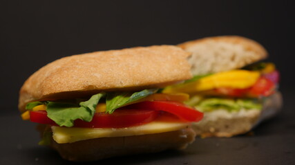 Delicious sandwich on a black background.