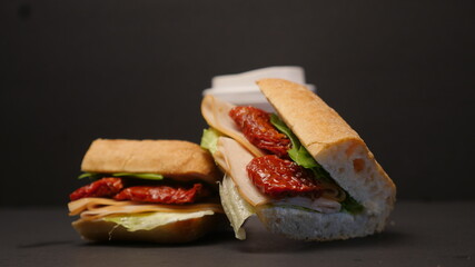 Delicious sandwich on a black background.