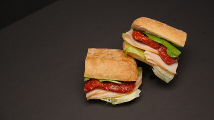 Delicious sandwich on a black background.