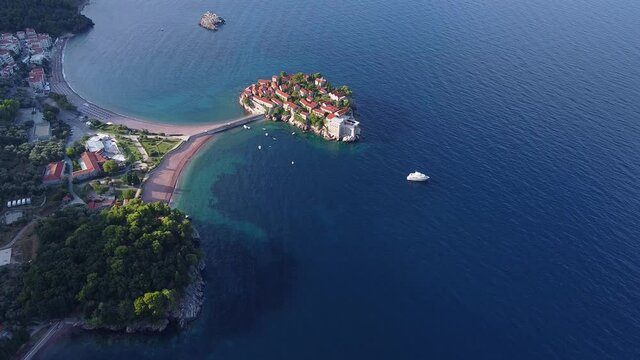 Aerial view of sea spaces with coastal part and small island. Perfect place for spending vacations there. Drone shot of Sveti Stefan (Saint Stephen) island in Montenegro.